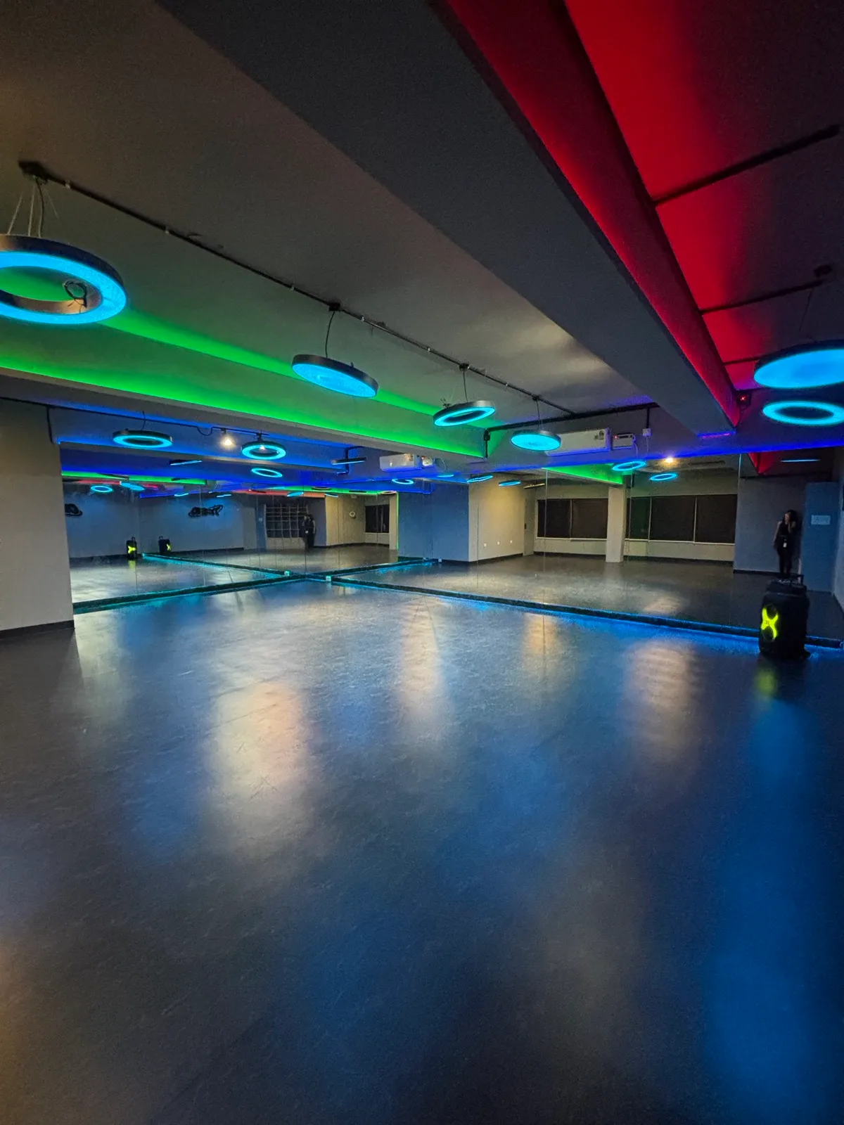 The ORBYT floor under blue ring lights and a red ceiling wash