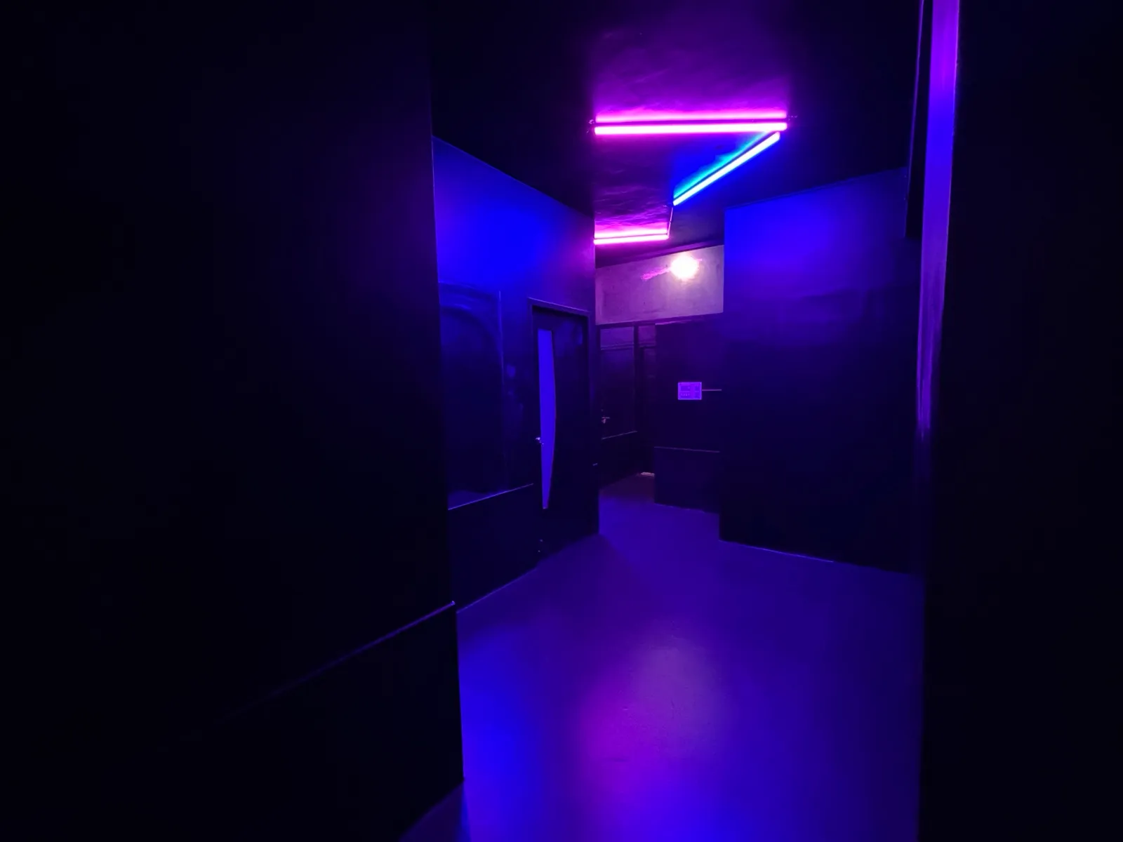 ORBYT's corridor lit in violet and pink neon